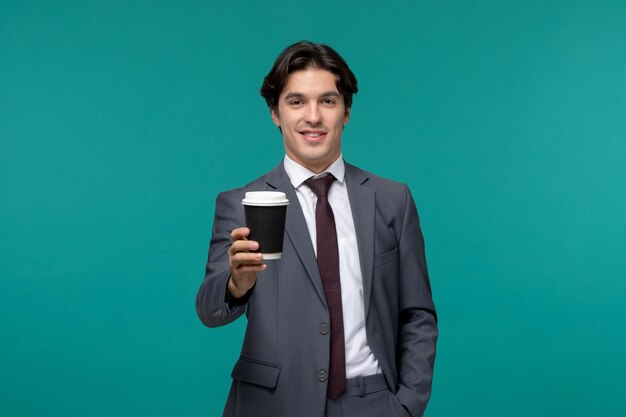 Business man stylish cute handsome man in grey office suit and tie showing coffee cup