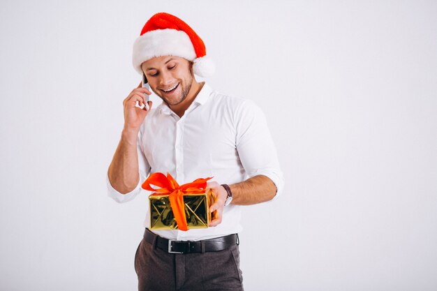 Business man talking on phone in santa hat isolated on white background