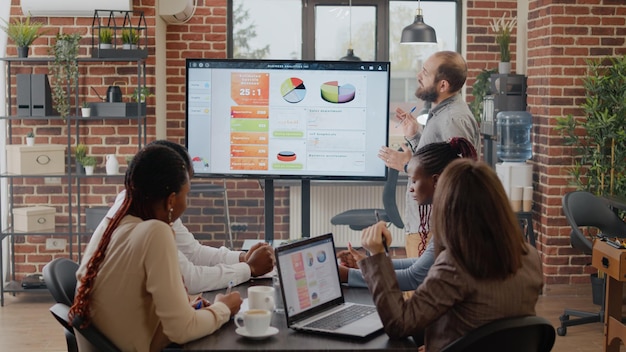 Business man talking to workmates about project planning and strategy in office. Person presenting analysis to colleagues for company development and financial growth. Presentation ideas