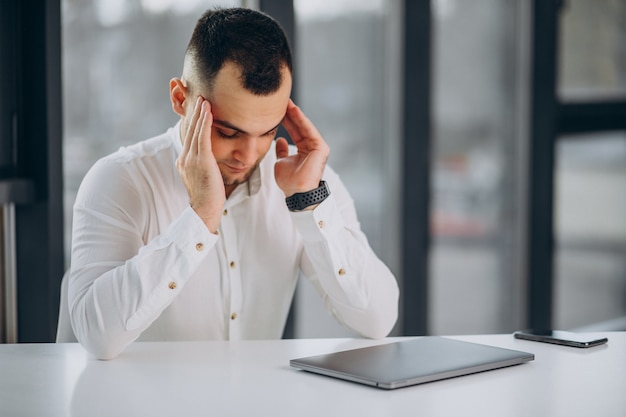 Foto gratuita uomo d'affari che utilizza laptop in ufficio