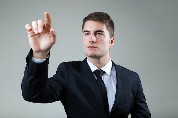 Business man with pointing to something or touching a screen.