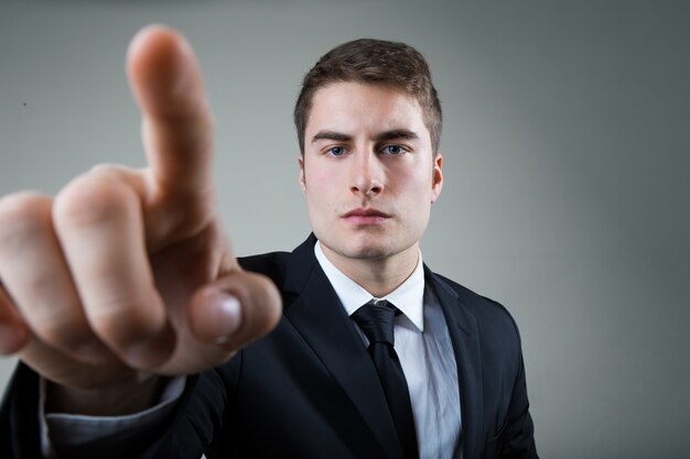 Business man with pointing to something or touching a screen.