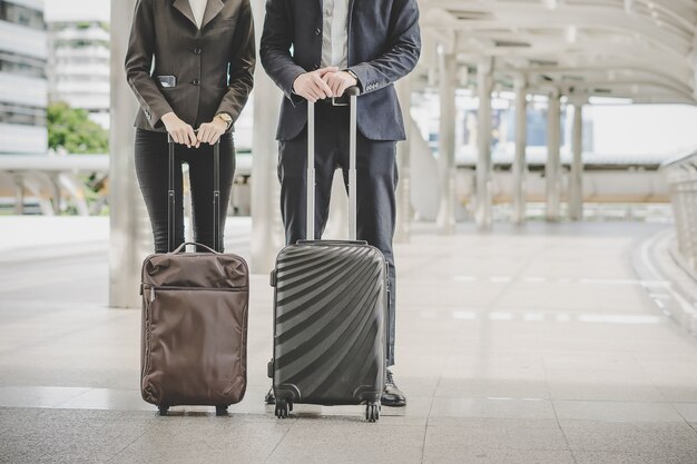 Business man and woman are going on business trip.