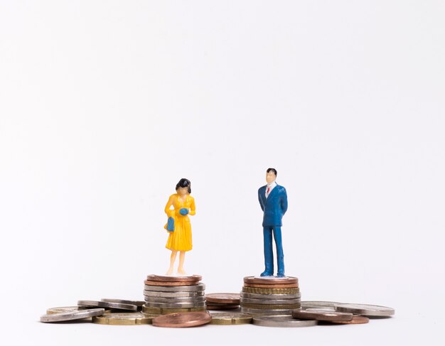 Business man and woman sitting on coins