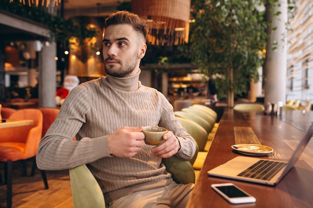 Business man working on a computer in a cafe