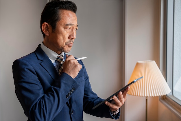 business man working on ipad side view