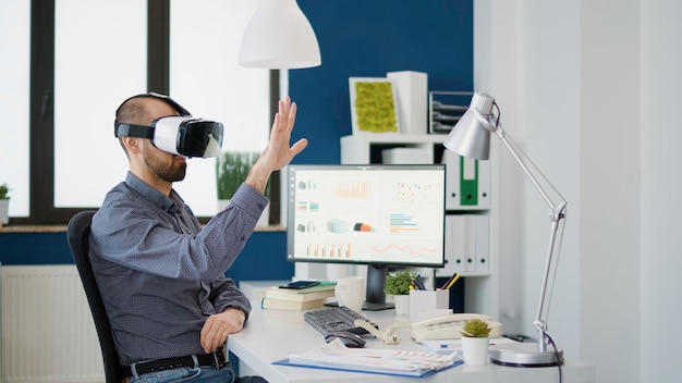 Business man working with vr glasses in company office, using virtual reality goggles with 3d interactive vision. Executive manager planning charts statistics for financial development.