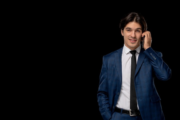 Business man young cute handsome guy in dark blue suit with the tie talking on the phone