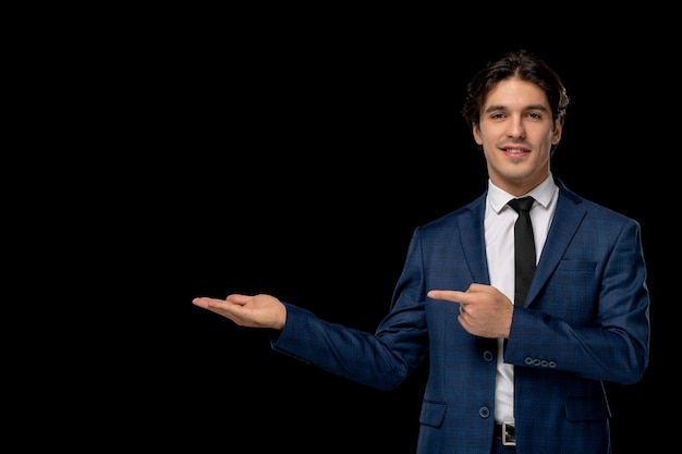 Free photo business man young handsome man in dark blue suit with the tie pointing to left