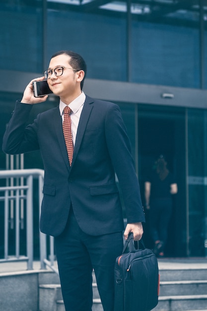 Business men answer phones at the office door