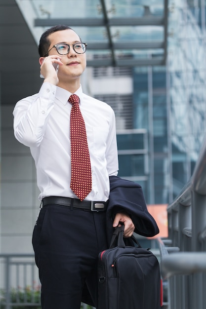Business men answer phones at the office door