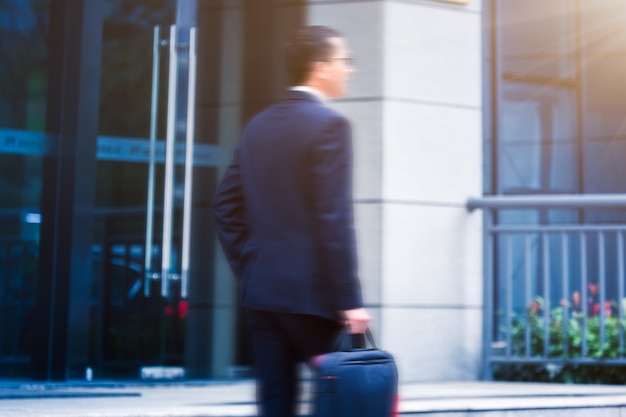 Business men carry laptops to the office building