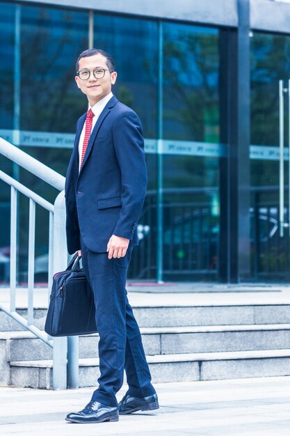 Business men carry laptops to the office building