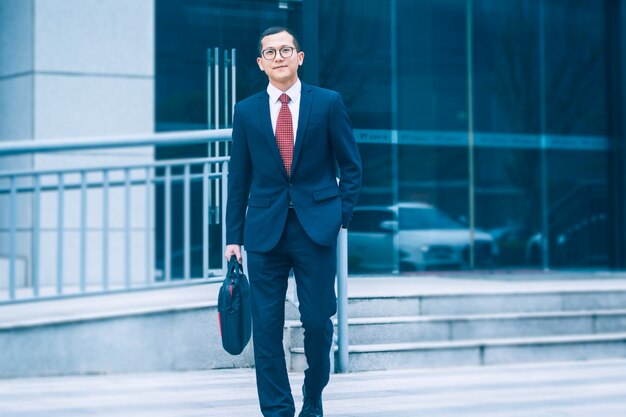 Business men carry laptops to the office building