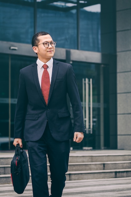 Business men carry laptops to the office building