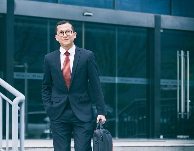 Business men carry laptops to the office building