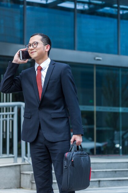 Business men carry laptops to the office building