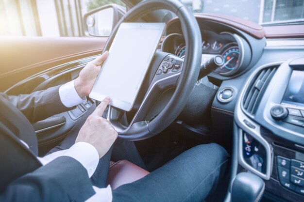 Business men work with tablet computers in their cars