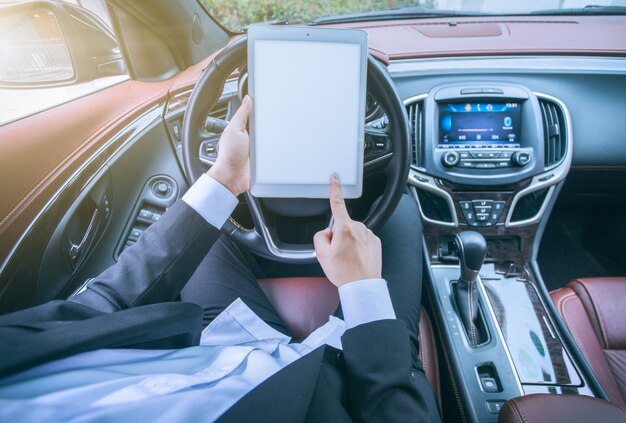 Business men work with tablet computers in their cars