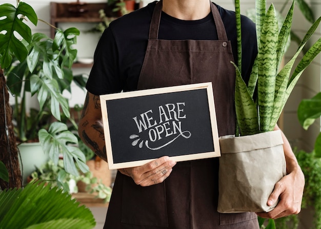 Free photo business owner holding we are open sign