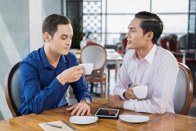 Business Partners Drinking Coffee in Restaurant