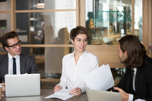 Business partners negotiating during meeting in boardroom