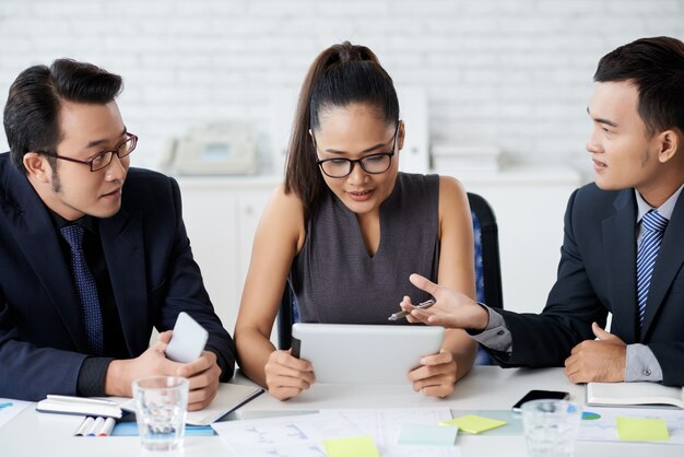 Business Partners Working On Project Together In Office