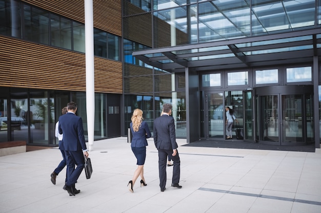 Business people entering in to an office building