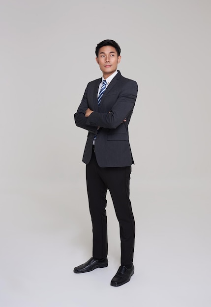 Free photo business people good looking in studio asian businessman in grey suit confident with crossed arms