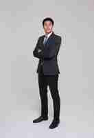 Free photo business people good looking in studio asian businessman in grey suit confident with crossed arms