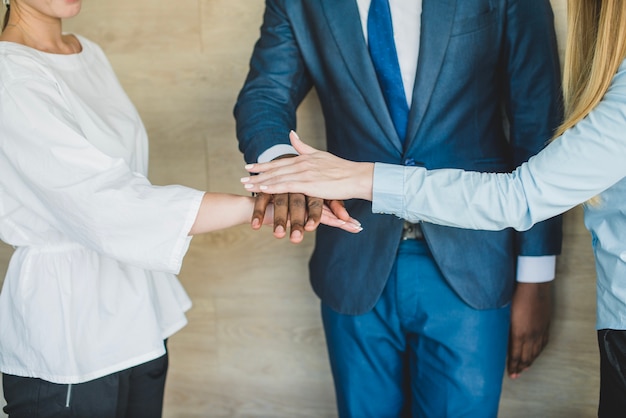 Business people laying hands together