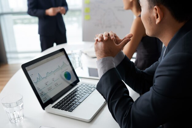 Business People Listening To Their Colleague At Meeting