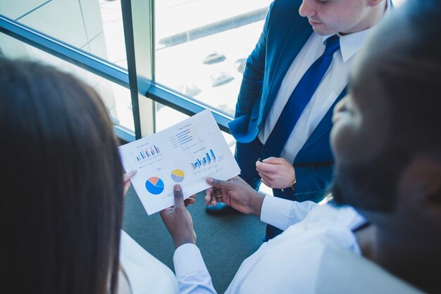 Business people looking at chart close up