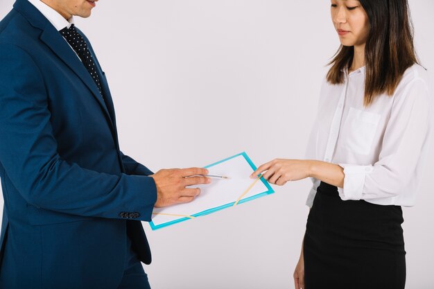 Business people looking at clipboard