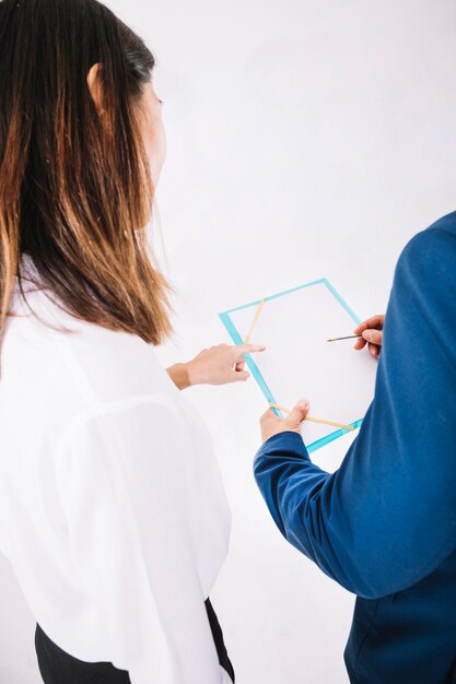 Business people looking at clipboard