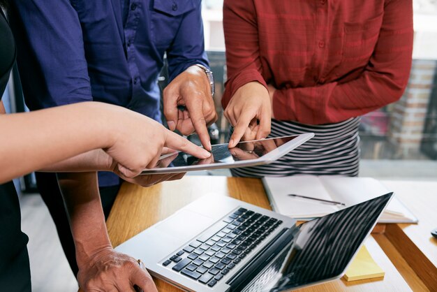 Business people pointing at tablet