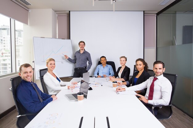 Business people posing smiling in a meeting room