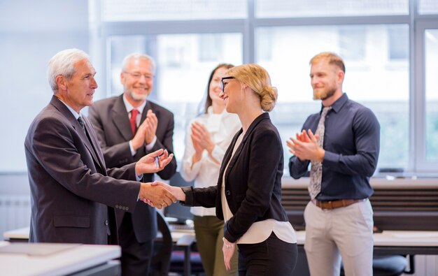 Business people shaking hands after successful negotiations in the office