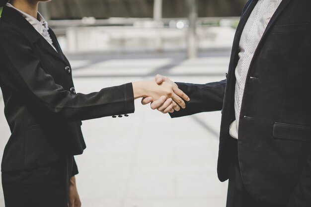 Business people shaking hands, finishing up meeting deals. Business concept.