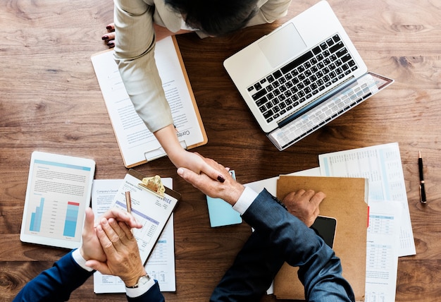 Free photo business people shaking hands together