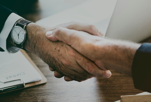 Business people shaking hands together