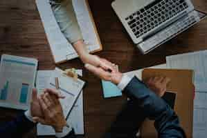 Free photo business people shaking hands together