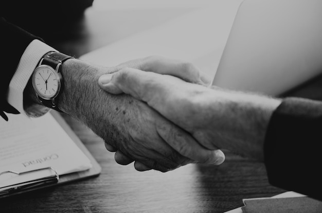 Free photo business people shaking hands together