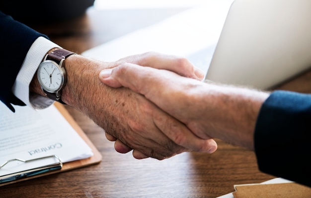 Business people shaking hands together