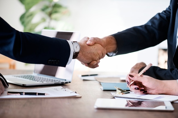 Business people shaking hands together-freepik