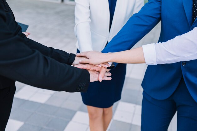 Business people stacking hands