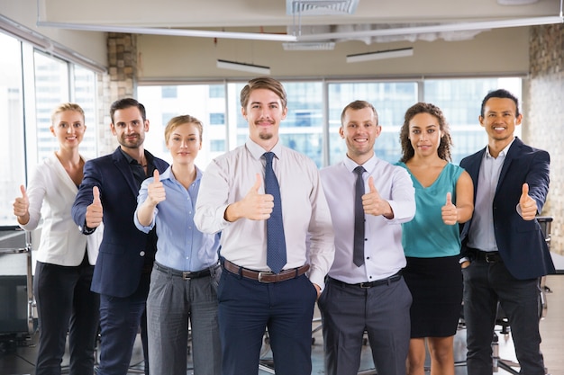 Business people standing in a row with thumbs up