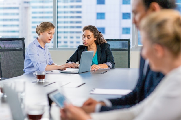 Business people talking at a meeting table