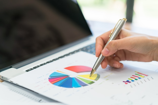 Business people using laptop and Financial charts at meeting office