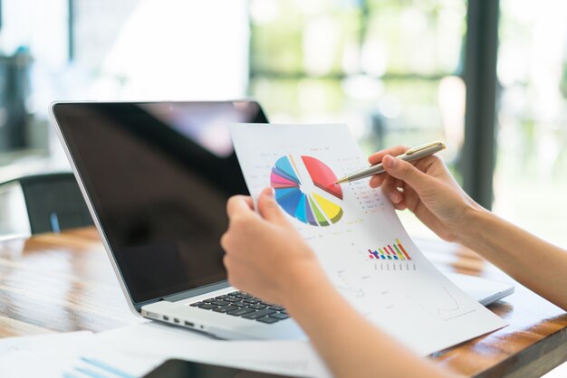 Business people using laptop and Financial charts at meeting office